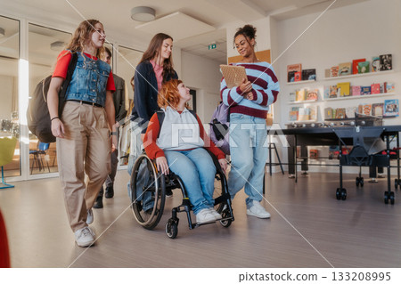 Teen students in school hallway, girl in wheelchair. 133208995
