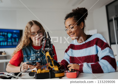 High school students working on robotics project. Girls in STEM. High school students working on robotics project. Girls in STEM. 133209006