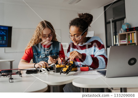 High school students working on robotics project. Girls in STEM. High school students working on robotics project. Girls in STEM. 133209008