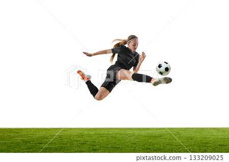 Female football player performing high-speed airborne attack kick Female football player performing high-speed airborne attack kick 133209025