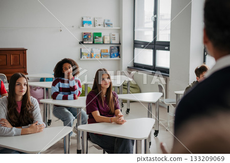 Confident teen student standing in modern classroom. Confident teen student standing in modern classroom. 133209069