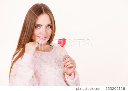 Beautiful woman holding heart shaped hand stick Beautiful woman holding heart shaped hand stick 133209116