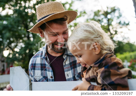 Little boy and father on farm, standing on fence. Little boy and father on farm, standing on fence. 133209197