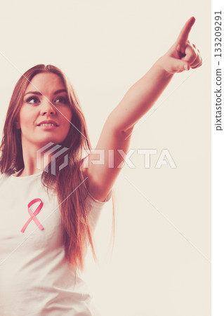 Woman pink cancer ribbon on chest pointing 133209291