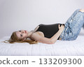 Side view od young pregnant woman lying on a bed 133209300