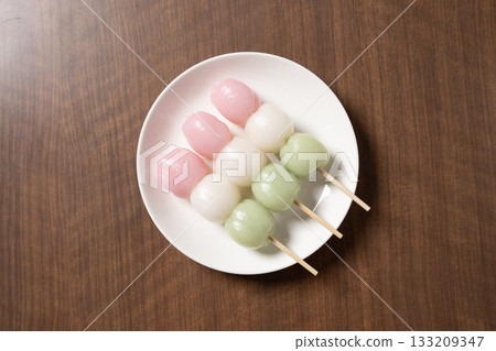 Three-colored dumplings on a white plate Three-colored dumplings on a white plate 133209347