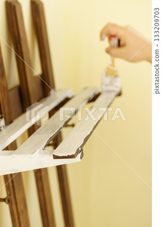 Person renovating wooden hanger Person renovating wooden hanger 133209703