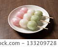 Three tricolored dumplings on a white plate 133209728