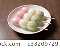 Three tricolored dumplings on a white plate 133209729