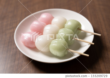 Three tricolored dumplings on a white plate Three tricolored dumplings on a white plate 133209729