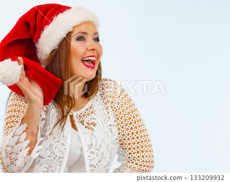 Smiling woman in christmas santa hat Smiling woman in christmas santa hat 133209932