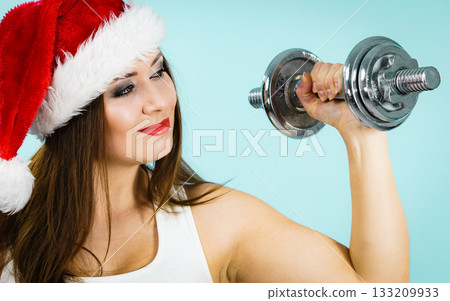 Santa claus woman lifting dumbbells 133209933