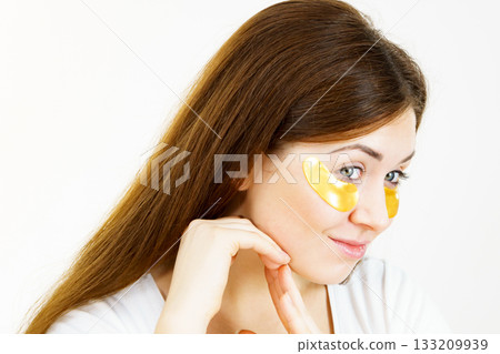 Woman with gold patches under eyes Woman with gold patches under eyes 133209939