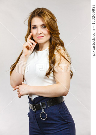 Woman wearing high waist trouser with belt Woman wearing high waist trouser with belt 133209952