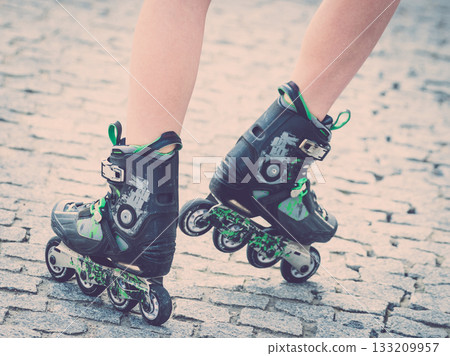 Woman legs wearing roller skates 133209957