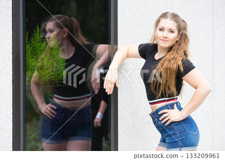 Fashionable teen presenting summer outfit Fashionable teen presenting summer outfit 133209961