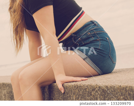 Female buttocks in denim shorts 133209970