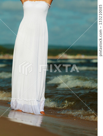 Young lady resting on beach. 133210085