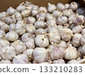 A lot of garlic in the box on sale in vegetable stand display at supermarket shop organic food, vegetarian food, healthy food. Close-up 133210283