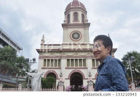 Asian elder woman standing front of Santa Cruz church ancient community of Portuguese Christian travel location in Thailand  133210943