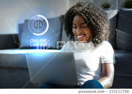 Woman using laptop to consult with online lawyer in modern living room setting Woman using laptop to consult with online lawyer in modern living room setting 133211798