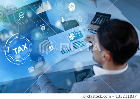Business professional analyzing financial data in a modern office during daytime Business professional analyzing financial data in a modern office during daytime 133211837