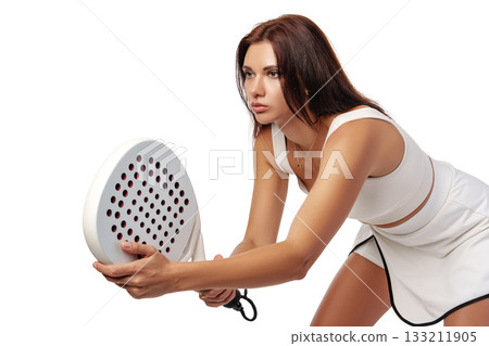 Woman preparing for a competitive padel match on a bright background 133211905