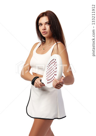 Young woman prepares to play paddle tennis in sporty outfit and focused expression 133211912