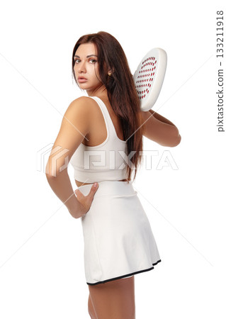 Young woman shows confidence in sportswear with paddle in hand during practice session Young woman shows confidence in sportswear with paddle in hand during practice session 133211918