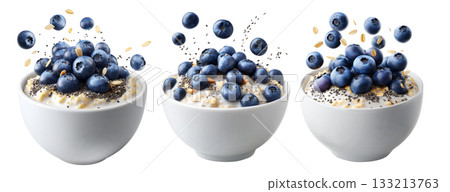 Fresh blueberries and chia seeds on creamy oatmeal in white ceramic bowl, isolated on white transparent background Fresh blueberries and chia seeds on creamy oatmeal in white ceramic bowl, isolated on white transparent background 133213763