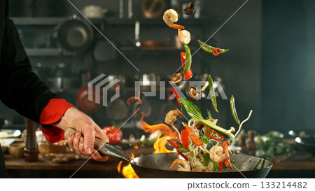 Freeze Motion of Flying Asian Meal with Vegetable and Prawns into Wok Pan Freeze Motion of Flying Asian Meal with Vegetable and Prawns into Wok Pan 133214482