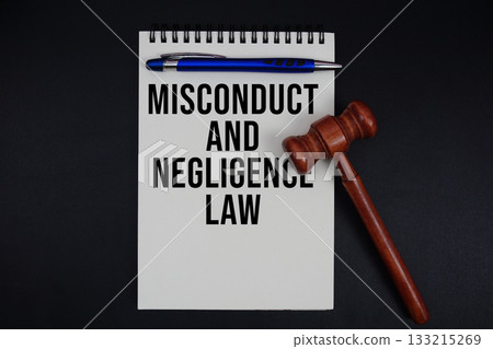 Misconduct And Negligence Law text written on notepad with gavel on black background 133215269
