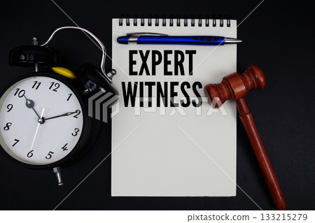 Expert Witness text written on notepad with gavel and alarm clock on black background Expert Witness text written on notepad with gavel and alarm clock on black background 133215279