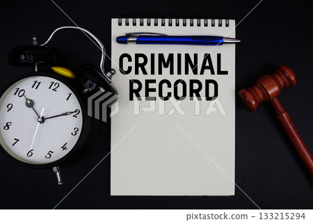 Criminal Record text written on notepad with gavel and alarm clock on black background Criminal Record text written on notepad with gavel and alarm clock on black background 133215294
