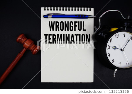 Wrongful Termination text written on notepad with gavel and alarm clock on black background Wrongful Termination text written on notepad with gavel and alarm clock on black background 133215336