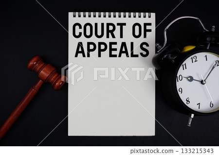 Court Of Appeals text written on notepad with gavel and alarm clock on black background Court Of Appeals text written on notepad with gavel and alarm clock on black background 133215343
