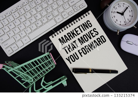 Marketing That Moves You Forward text written on notepad with keyboard and trolley shopping cart on black background Marketing That Moves You Forward text written on notepad with keyboard and trolley shopping cart on black background 133215374