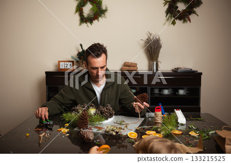 Christmas Craft Night At Home: Man Making Pinecone Wreaths For Holiday Decor 133215525