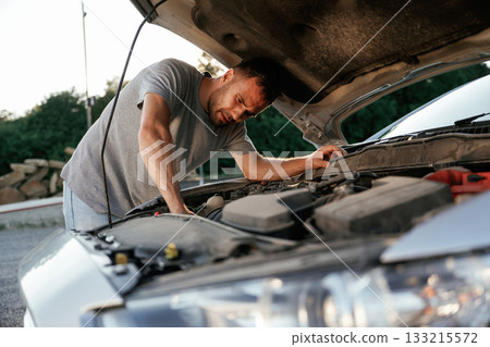 Problem, fixing and repairing the broken automobile. Man is with his car outdoors Problem, fixing and repairing the broken automobile. Man is with his car outdoors 133215572