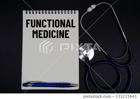 Notepad with "Functional Medicine" a pen, gavel, and stethoscope on a black background Notepad with "Functional Medicine" a pen, gavel, and stethoscope on a black background 133215643