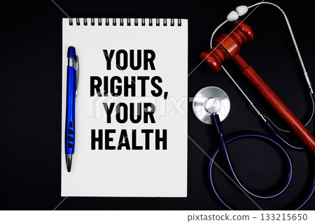 Notepad with "Your Rights, Your Health" a pen, gavel, and stethoscope on a black background Notepad with "Your Rights, Your Health" a pen, gavel, and stethoscope on a black background 133215650