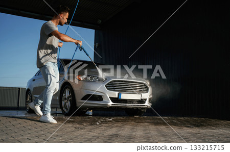 Service of car wash. Man is with his automobile outdoors Service of car wash. Man is with his automobile outdoors 133215715