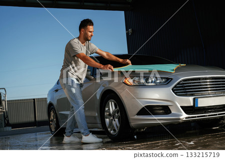 Cloth, cleaning the automobile. Man is with his car outdoors 133215719