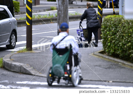 Yokohama cityscape in Japan: Aging society (an elderly woman going shopping. There is also a man in a wheelchair on the street...) = Yokohama city 133215833