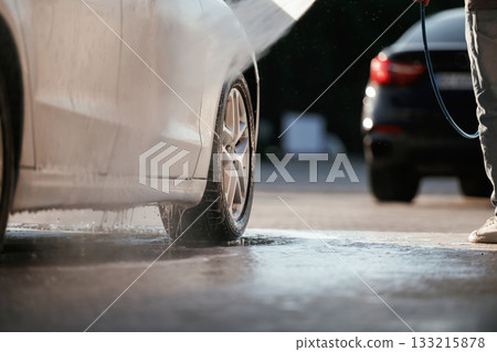 Car wash conception. Man is with his automobile outdoors Car wash conception. Man is with his automobile outdoors 133215878