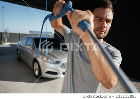 Ready to wash the automobile. Man is with his car outdoors 133215883