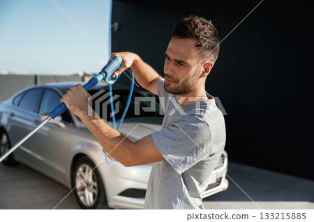 Ready to wash the automobile. Man is with his car outdoors 133215885