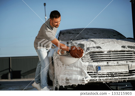 Process of washing the automobile. Man is with his car outdoors Process of washing the automobile. Man is with his car outdoors 133215903