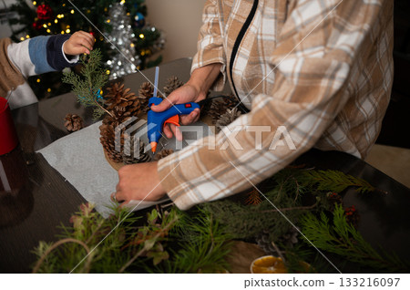 Family Christmas Craft: Gluing Pinecones And Greenery For Holiday Decor Family Christmas Craft: Gluing Pinecones And Greenery For Holiday Decor 133216097