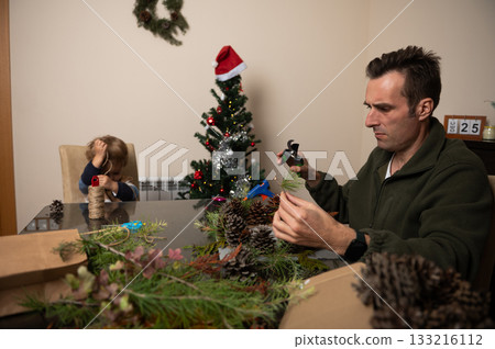 Family Christmas Crafting At Home: Father, Child And Tree Decor In A Cozy Setting 133216112